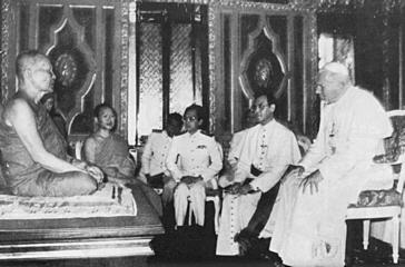 John Paul II stoops to Buddhist leader